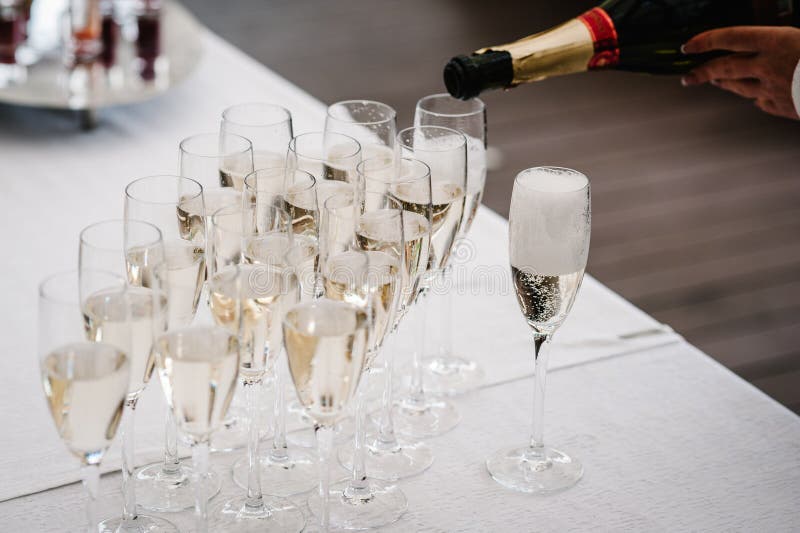 De mens overhandigt gietende champagne van een fles in glas royalty-vrije stock afbeeldingen De mens overhandigt gietende champagne van een fles in glas royalty-vrije stock afbeeldingen