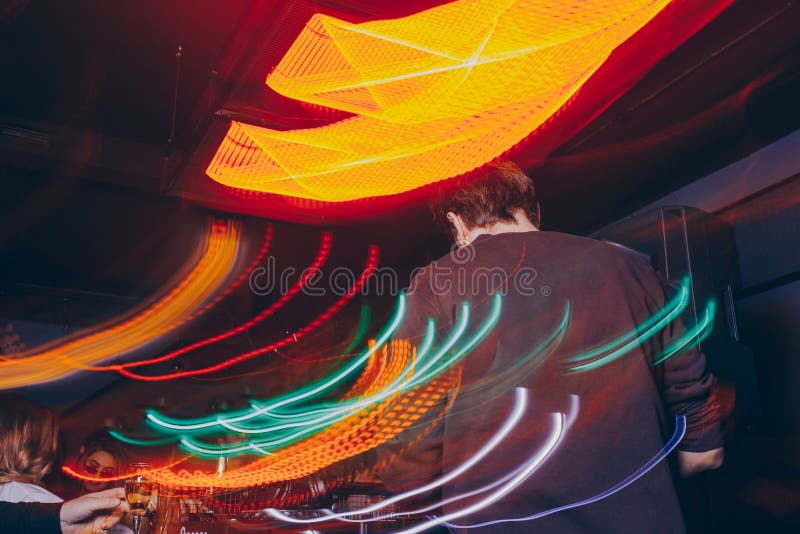 De mixer van producentendj in een nachtclub met het gloeien speelt musical ijlt Elektronische de Trancesamenstelling van Dubstep royalty-vrije stock fotografie De mixer van producentendj in een nachtclub met het gloeien speelt musical ijlt Elektronische de Trancesamenstelling van Dubstep royalty-vrije stock fotografie