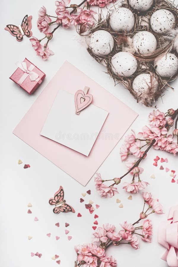 De mooie spot van de de groetkaart van pastelkleur roze Pasen omhoog met bloesemdecoratie, harten, eieren in kartondoos op wit bu stock fotografie De mooie spot van de de groetkaart van pastelkleur roze Pasen omhoog met bloesemdecoratie, harten, eieren in kartondoos op wit bu stock fotografie
