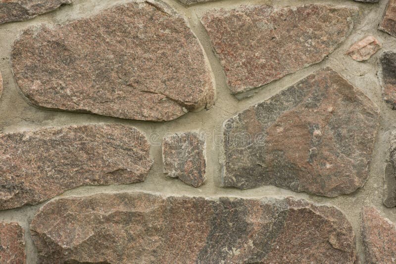 De muur geweven achtergrond van de steen Graniet stock fotografie De muur geweven achtergrond van de steen Graniet stock fotografie