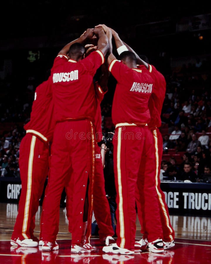 The 1990's Houston Rockets meet at the free throw circle after introductions. Otis Thorpe, Hakeem Olajuwon, Kenny Smith. (Image taken from color negative). The 1990's Houston Rockets meet at the free throw circle after introductions. Otis Thorpe, Hakeem Olajuwon, Kenny Smith. (Image taken from color negative)