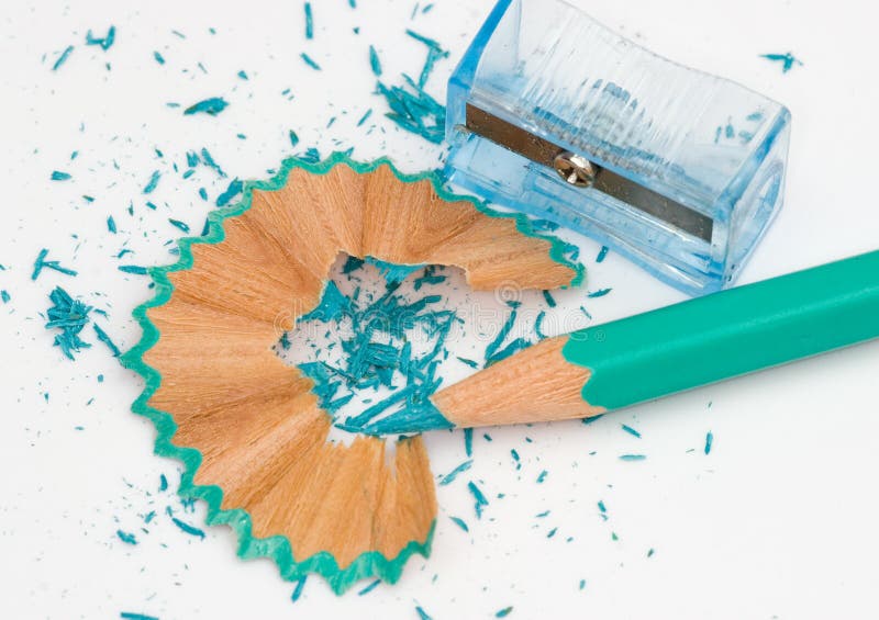 Colorful pencil and wooden shaving made by a sharpener. Colorful pencil and wooden shaving made by a sharpener