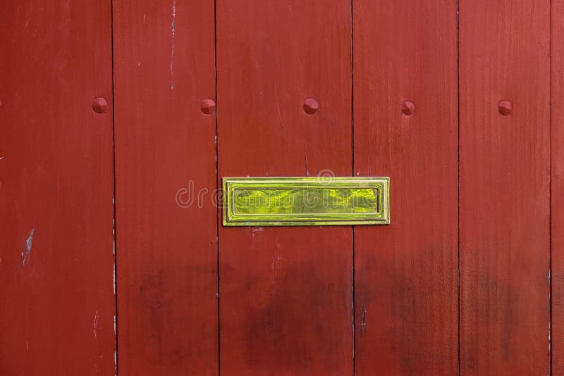 De opgepoetste groef van de messingsbrievenbus op een geschilderde houten poort royalty-vrije stock foto De opgepoetste groef van de messingsbrievenbus op een geschilderde houten poort royalty-vrije stock foto