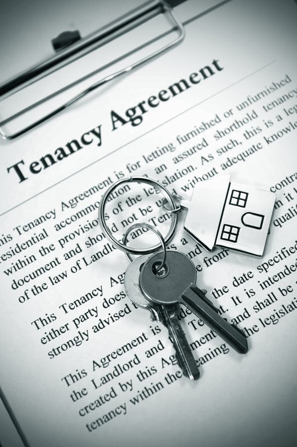 Tenancy agreement and key with symbolic house keyring. Tenancy agreement and key with symbolic house keyring