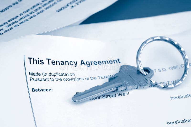 Some paperwork concerning tenancy agreement with key in blue tone. Some paperwork concerning tenancy agreement with key in blue tone