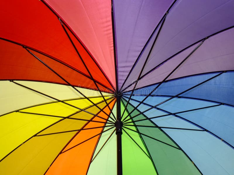 Close-up of a multicoloured umbrella from underneath. Close-up of a multicoloured umbrella from underneath.