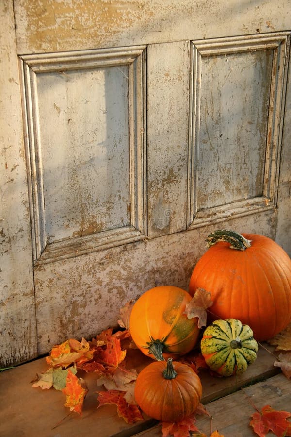 Pumpkins, broom and gourds at the door ready for halloween. Pumpkins, broom and gourds at the door ready for halloween