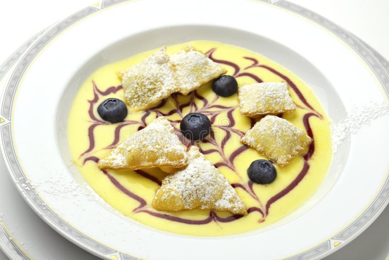 Dessert bowl of Fruit ravioli on English custard. Dessert bowl of Fruit ravioli on English custard