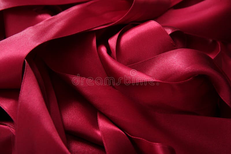 Red satin ribbons in a messy mess texture background. Red satin ribbons in a messy mess texture background