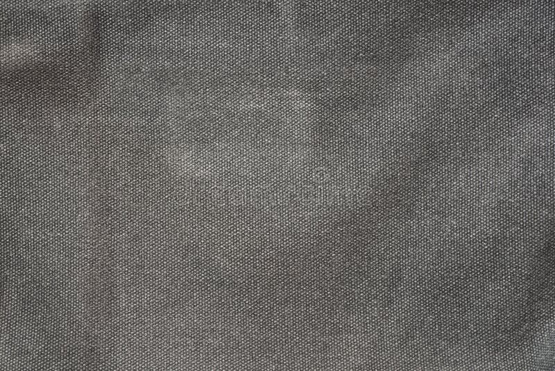 De ruwe donkere grijze achtergrond van de stoffen textieltextuur royalty-vrije stock foto's De ruwe donkere grijze achtergrond van de stoffen textieltextuur royalty-vrije stock foto's