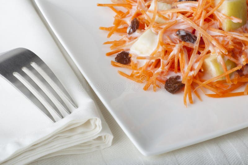 Fresh carrot salad with shredded carrots, raisins, apples and a light curry yogurt dressing. Fresh carrot salad with shredded carrots, raisins, apples and a light curry yogurt dressing.