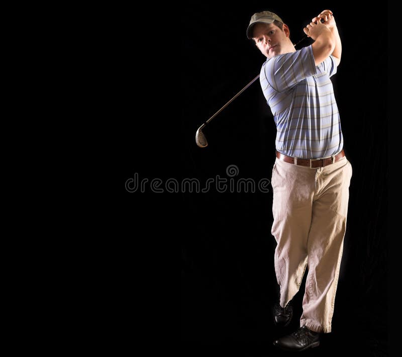 Golfer looking at golf ball after swinging club, facing forward. Golfer looking at golf ball after swinging club, facing forward