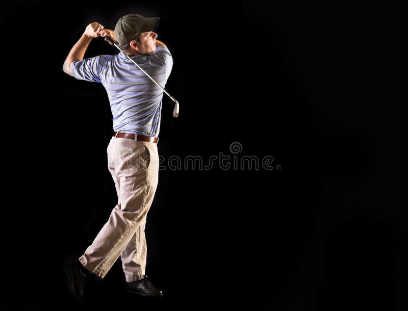 Golfer looking at golf ball after swinging club. Golfer looking at golf ball after swinging club