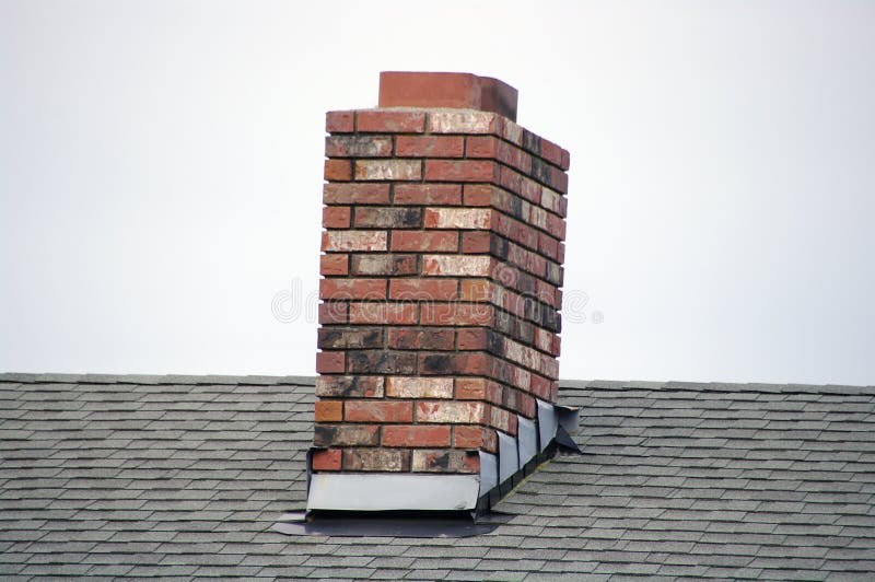 A red brick masonry chimney on a residential home. A red brick masonry chimney on a residential home.