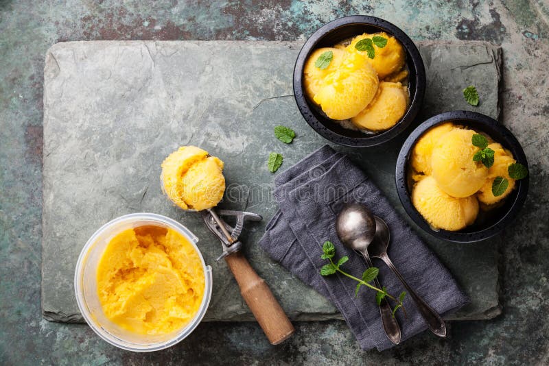 De sorbet van het mangoroomijs met muntbladeren royalty-vrije stock afbeeldingen De sorbet van het mangoroomijs met muntbladeren royalty-vrije stock afbeeldingen