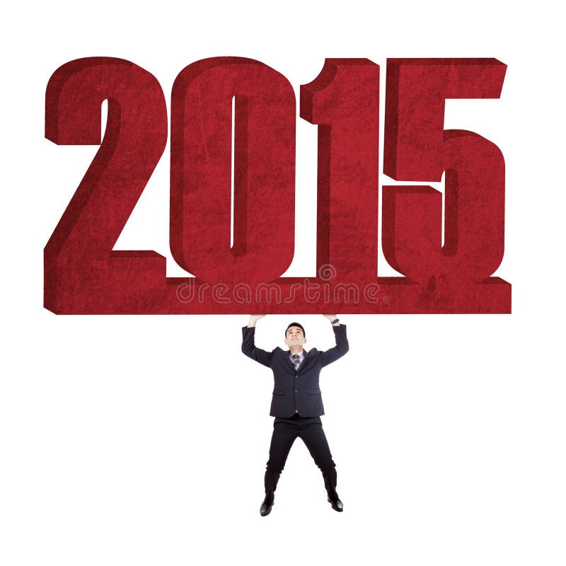 Young businessman lifts number 2015 in studio, isolated over white background. Young businessman lifts number 2015 in studio, isolated over white background