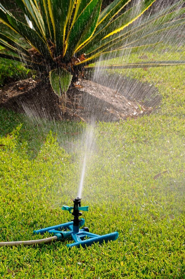 Impact garden sprinkler on a Mediterranean lawn, Costa del Sol, Andalucia, Spain, Western Europe. Impact garden sprinkler on a Mediterranean lawn, Costa del Sol, Andalucia, Spain, Western Europe.