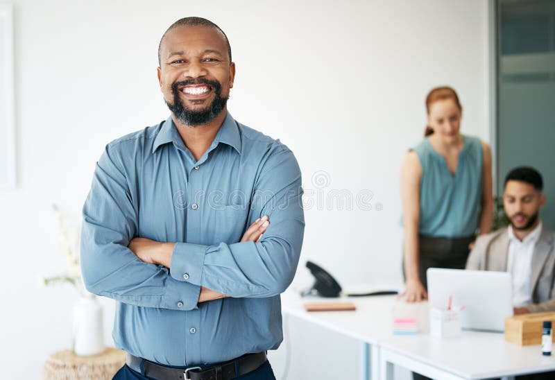 De stabilire a exemplului adecvat pentru echipă. un om de afaceri chipeș și matur care stă în birou cu brațele împăturite în timp stock photos