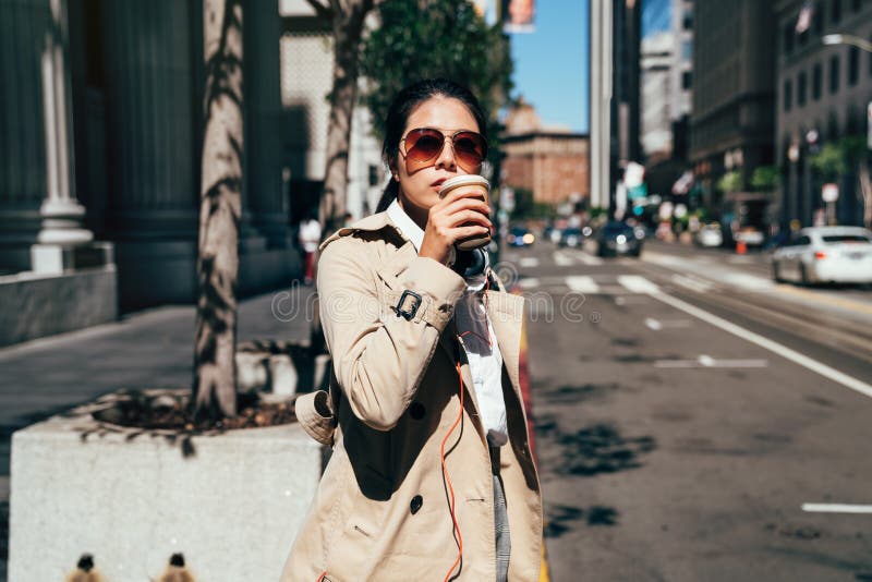 San francisco city commute waiting taxi cab. Asian businesswoman walking to work in the morning commuting drinking coffee cup on street with cars in the background banner. People commuters lifestyle. San francisco city commute waiting taxi cab. Asian businesswoman walking to work in the morning commuting drinking coffee cup on street with cars in the background banner. People commuters lifestyle