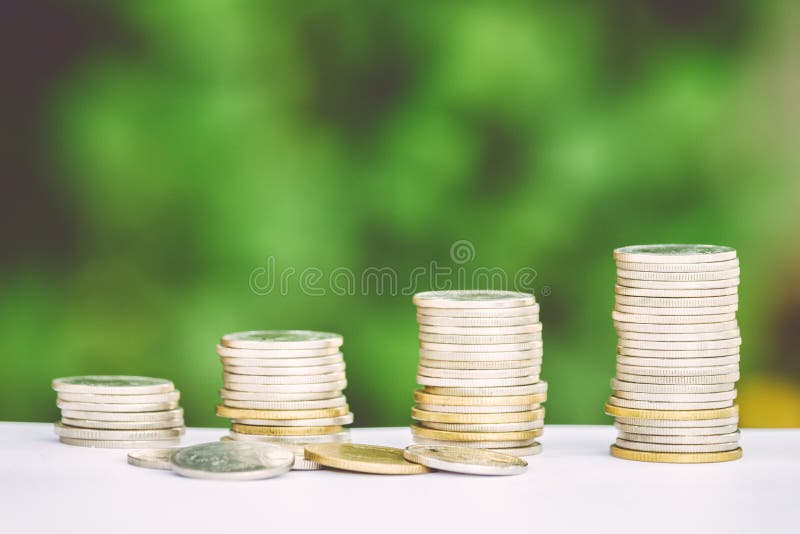 De stapel van het geldmuntstuk het groeien grafiek met groene achtergrond stock fotografie De stapel van het geldmuntstuk het groeien grafiek met groene achtergrond stock fotografie