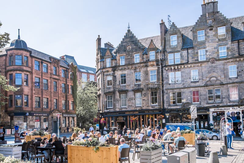 Scotland, Edinburg - August 24, 2022: Victoria street with beautiful curve and colourful shopfronts, built in 1860th and designed in the fashionable Scots Baronial style. Scotland, Edinburg - August 24, 2022: Victoria street with beautiful curve and colourful shopfronts, built in 1860th and designed in the fashionable Scots Baronial style.