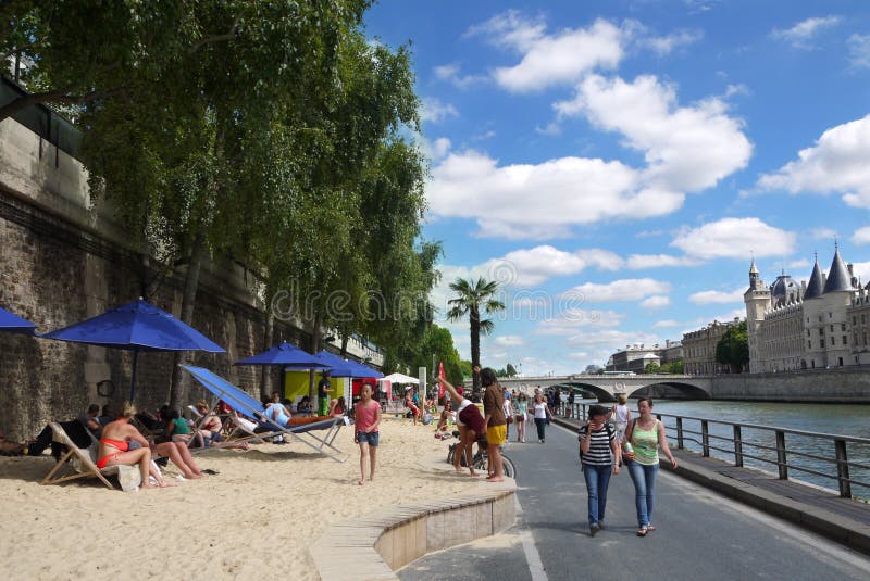 The Seine riverbanks transformed into beaches for some weeks during the summer. The Conciergerie is to be seen in the background. Paris France. The Seine riverbanks transformed into beaches for some weeks during the summer. The Conciergerie is to be seen in the background. Paris France.