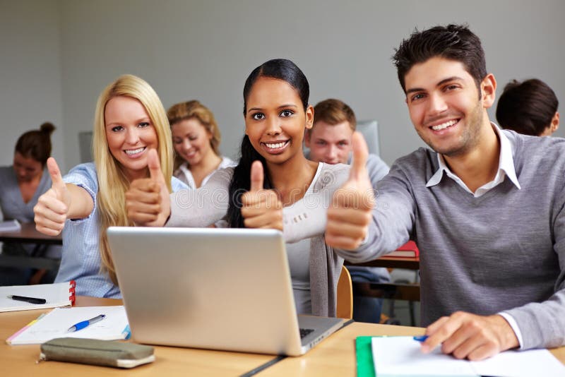 Successful students in class holding thumbs up. Successful students in class holding thumbs up