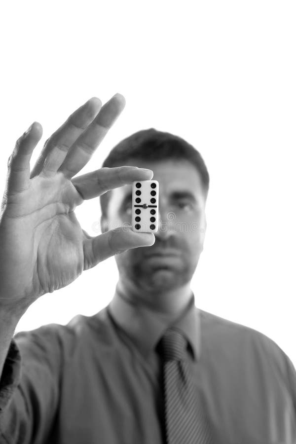 Businessman holding domino tile on hand, business winner strategy. Businessman holding domino tile on hand, business winner strategy