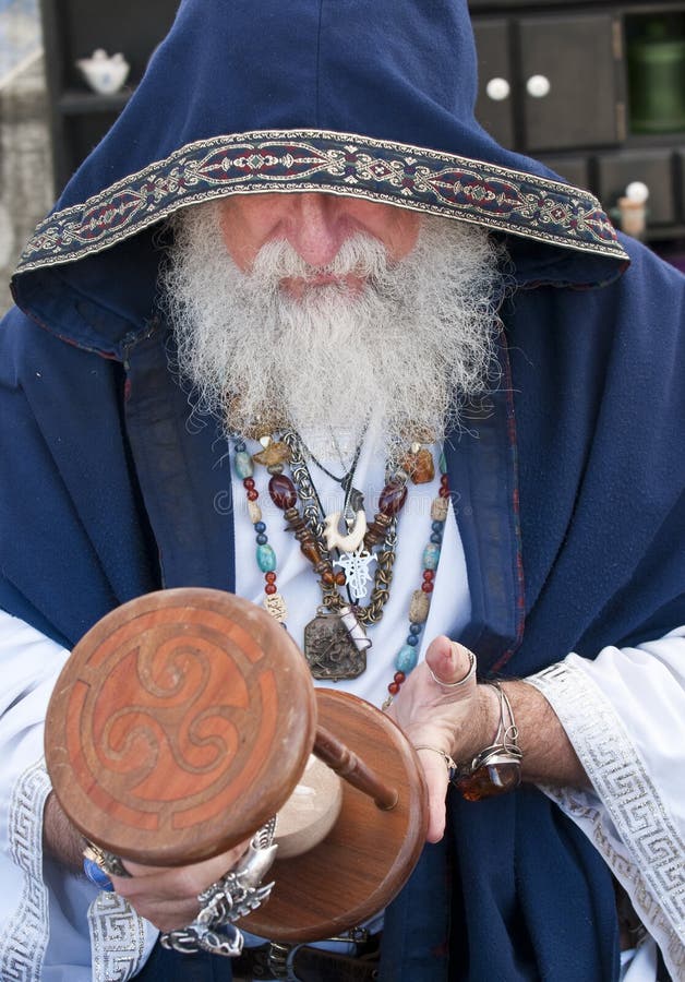 Old man, fortune teller looking at hour glass. Old man, fortune teller looking at hour glass.