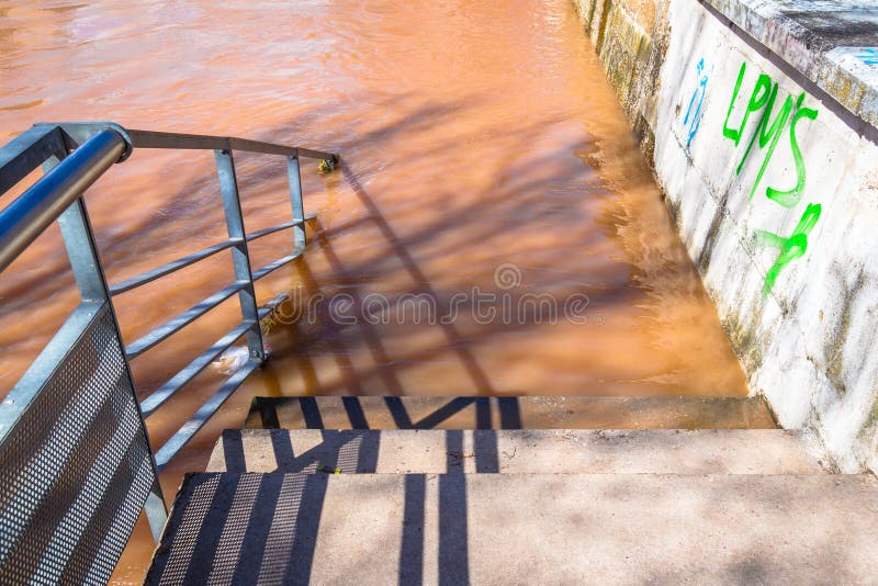 Stair access to a flooding river. Stair access to a flooding river.