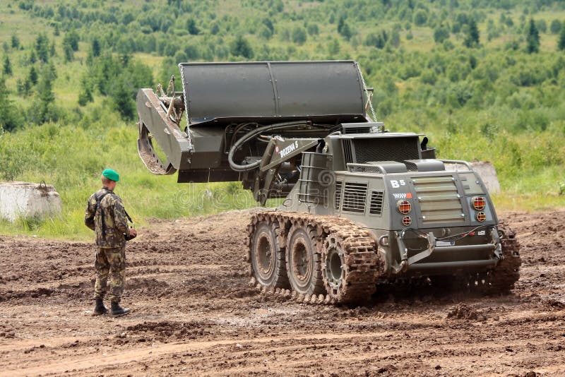 A remote-controlled mine destroyer Bozena, which belongs to the arsenal of Czech army, being controlled by a soldier during a military show and exhibition in a military area Brdy, Czech Republic. A remote-controlled mine destroyer Bozena, which belongs to the arsenal of Czech army, being controlled by a soldier during a military show and exhibition in a military area Brdy, Czech Republic