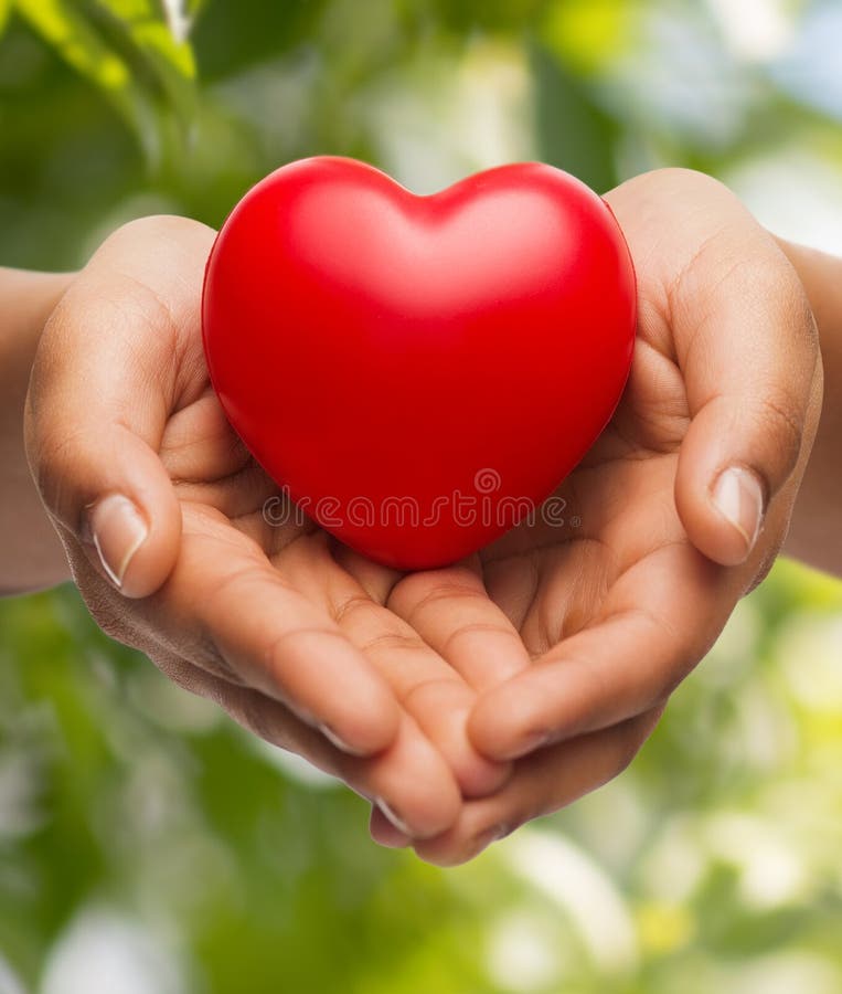 People, relationship and love concept - close up of womans cupped hands showing red heart. People, relationship and love concept - close up of womans cupped hands showing red heart
