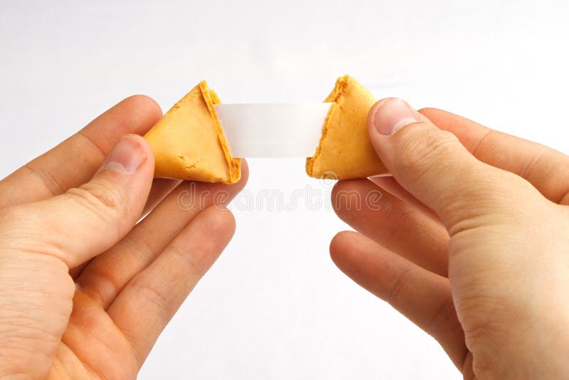 Fortune cookie being pulled apart with a blank fortune against a white background. Fortune cookie being pulled apart with a blank fortune against a white background