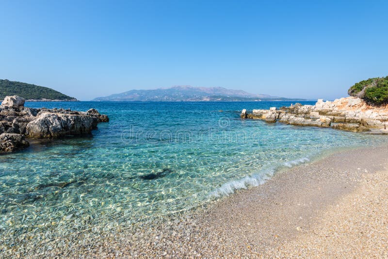 Amazing empty beach between the Twin Islands of Ksamil in Albania (Isole Gemelle di Ksamil). Corfu island in the background (Greece. Amazing empty beach between the Twin Islands of Ksamil in Albania (Isole Gemelle di Ksamil). Corfu island in the background (Greece