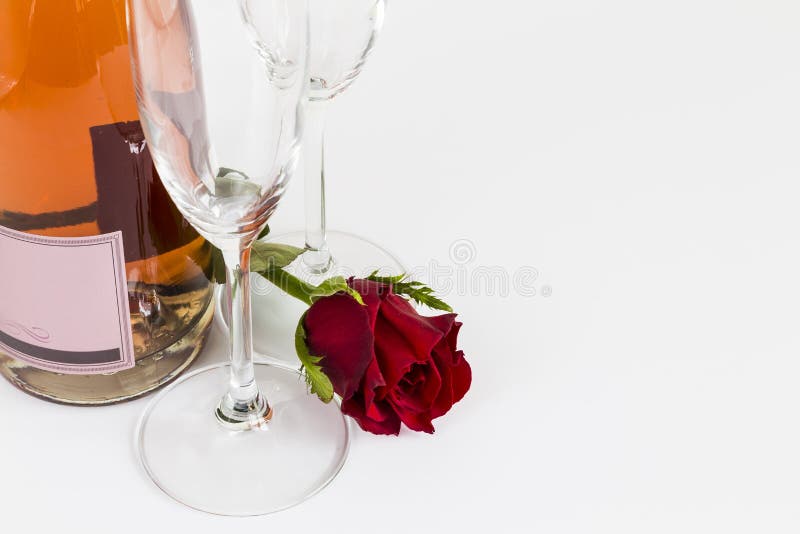 Rosé champagne bottle with flutes and rose. Rosé champagne bottle with flutes and rose.