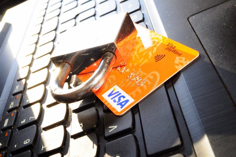 Credit card on a keyboard and a lock, credit card security. Credit card on a keyboard and a lock, credit card security