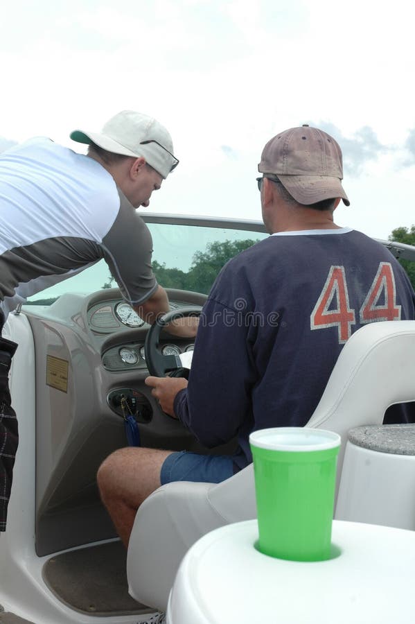 What's wrong with this boat? Friend helps driver. Boating fun. What's wrong with this boat? Friend helps driver. Boating fun.