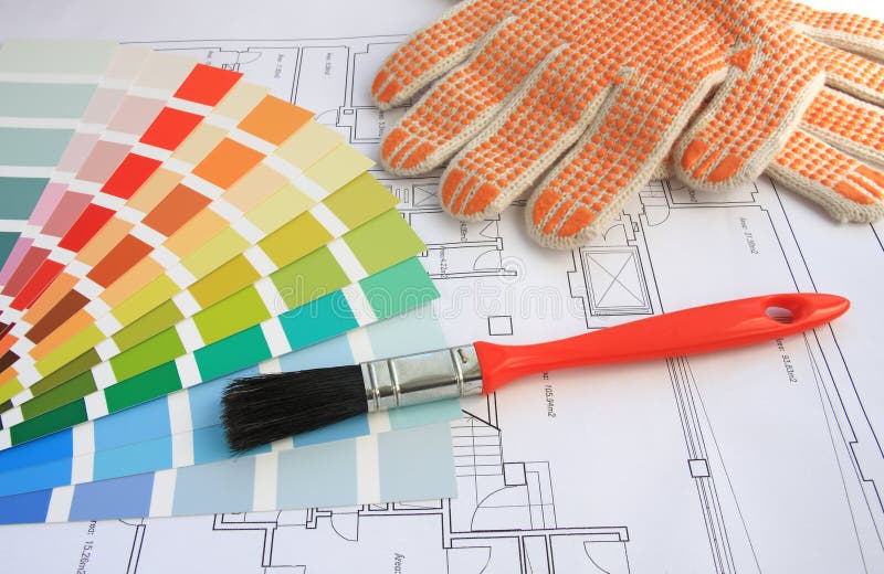 A color guide, a brush and gloves with a house plan on background. A color guide, a brush and gloves with a house plan on background