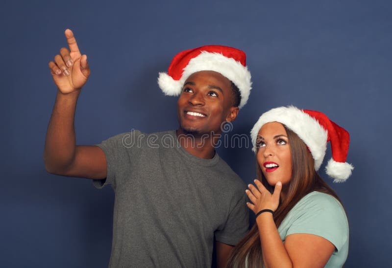 De verraste vrouwenman die jongelui van de de vakantiepartij van de Kerstman december van de Kerstmis de rode hoed benadrukken ko royalty-vrije stock fotografie De verraste vrouwenman die jongelui van de de vakantiepartij van de Kerstman december van de Kerstmis de rode hoed benadrukken ko royalty-vrije stock fotografie