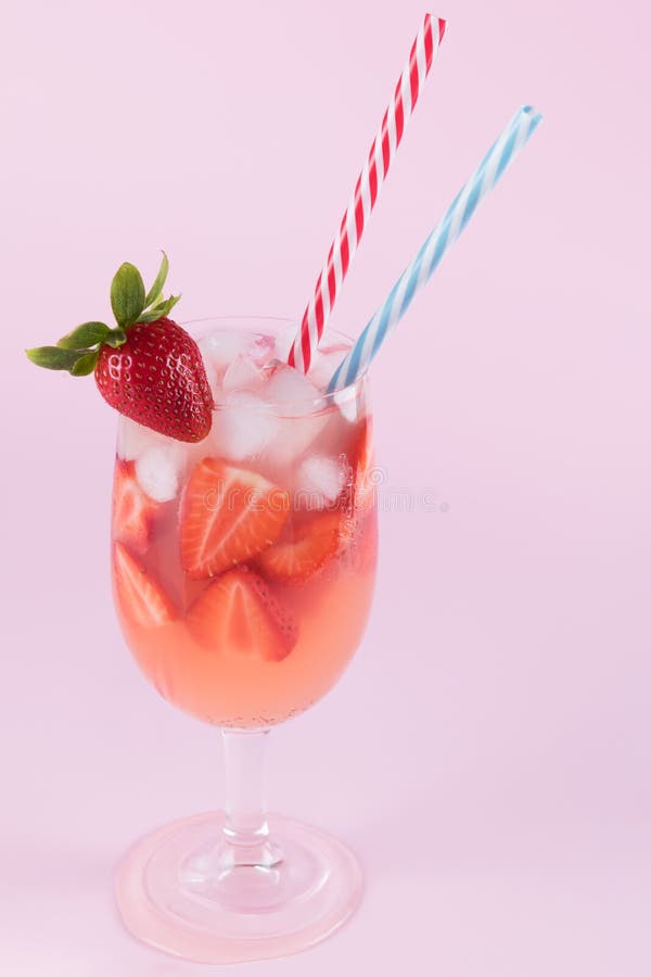 De de verse cocktail en ijsblokjes van de aardbeizomer Glas met aardbei, ijs en wijn - aardbeisangria op een pastelkleurroze royalty-vrije stock foto De de verse cocktail en ijsblokjes van de aardbeizomer Glas met aardbei, ijs en wijn - aardbeisangria op een pastelkleurroze royalty-vrije stock foto