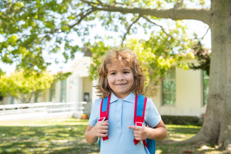 Back to school. Pupil of primary school on the way to study. Beginning of lessons. Boy outdoors near school park. Back to school. Pupil of primary school on the way to study. Beginning of lessons. Boy outdoors near school park