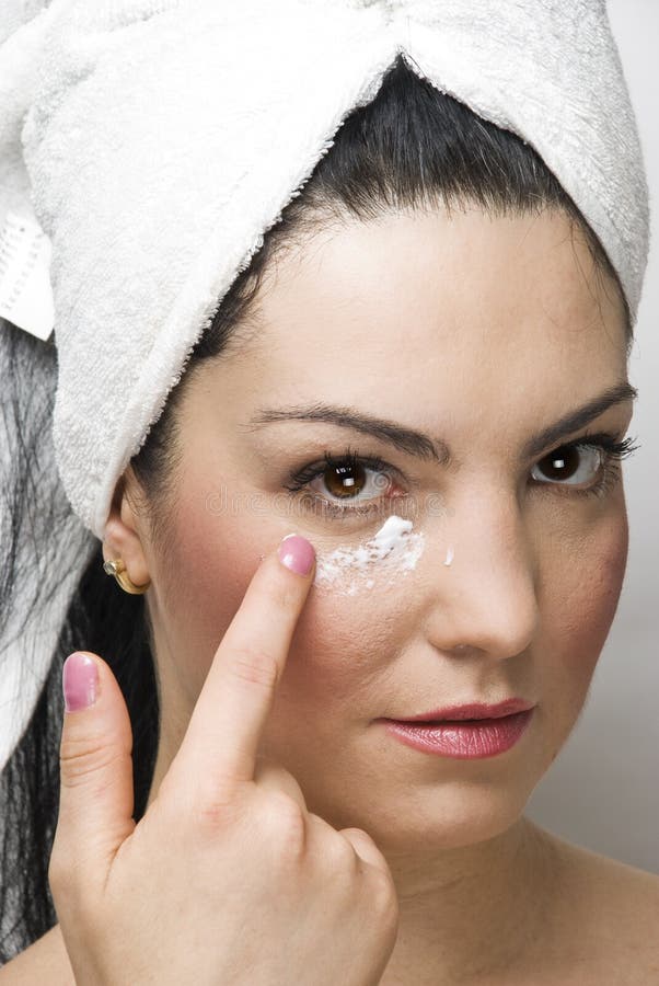 Close up of woman at day spa applying cream of face,check also. Close up of woman at day spa applying cream of face,check also