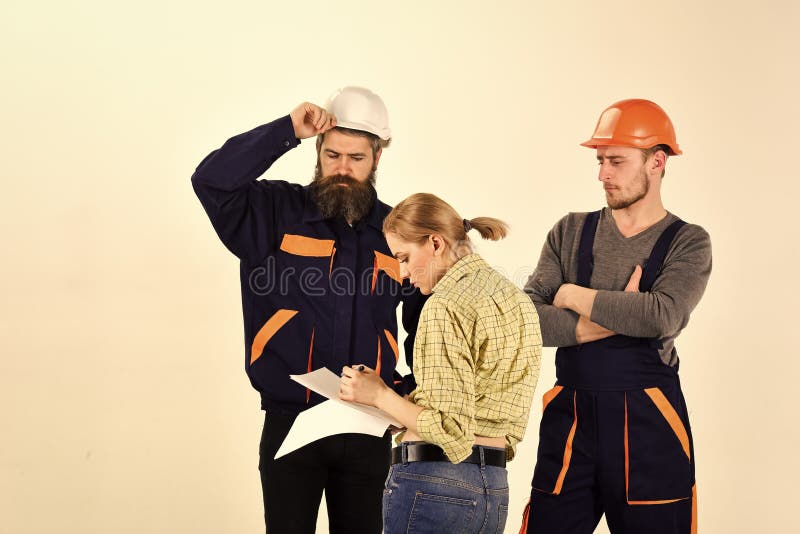 De vrouw wijzigt plan van reparatie Misverstandconcept Brigade van arbeiders, bouwers in helmen, herstellers, dame het debatteren stock fotografie De vrouw wijzigt plan van reparatie Misverstandconcept Brigade van arbeiders, bouwers in helmen, herstellers, dame het debatteren stock fotografie