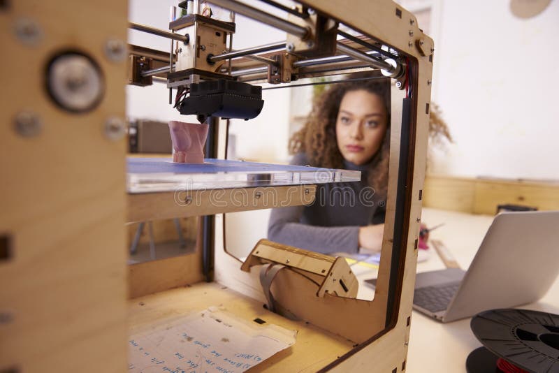 Female Designer Working With 3D Printer In Design Studio. Female Designer Working With 3D Printer In Design Studio