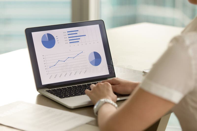 Businesswoman at desk analyzing statistic data on laptop screen. Female entrepreneur examines company financial results on computer. Woman making business presentation with graphs, stats and diagrams. Businesswoman at desk analyzing statistic data on laptop screen. Female entrepreneur examines company financial results on computer. Woman making business presentation with graphs, stats and diagrams