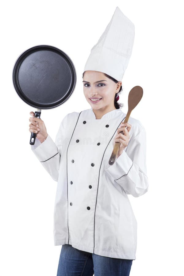 De de vrouwelijke spatel en pan van de chef-kokholding royalty-vrije stock fotografie De de vrouwelijke spatel en pan van de chef-kokholding royalty-vrije stock fotografie