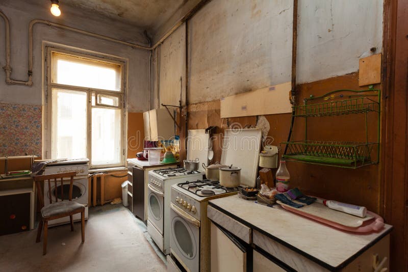 Dirty kitchen with furniture and gas stoves is in the apartment for temporary living existence refugees who were forced to migrate and emigrate from other countries. Dirty kitchen with furniture and gas stoves is in the apartment for temporary living existence refugees who were forced to migrate and emigrate from other countries.