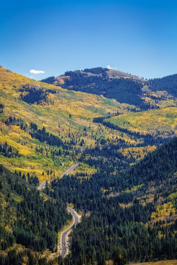 View of highway 190 going up Big Cottonwood Canyon to Brighton ski resort and Solitude ski resort with autumn colors in the Wasatch national forest in Utah USA. View of highway 190 going up Big Cottonwood Canyon to Brighton ski resort and Solitude ski resort with autumn colors in the Wasatch national forest in Utah USA.