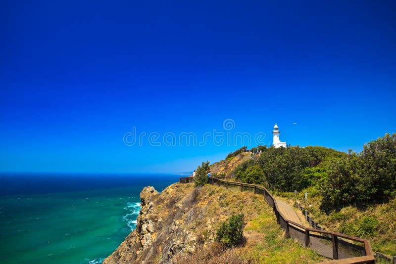 Byron Bay Lighthouse Framed Against Blue Sky With Hang Glider in Distance. Byron Bay Lighthouse Framed Against Blue Sky With Hang Glider in Distance