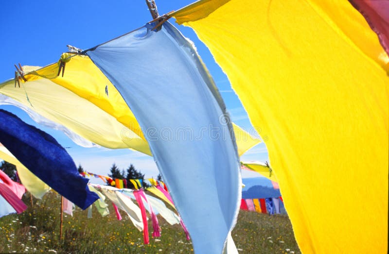 Colorful garments pinned on a clothes line catching the wind. Scanned from 35mm slide. Colorful garments pinned on a clothes line catching the wind. Scanned from 35mm slide.